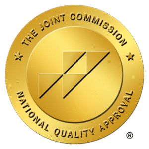 The Joint Commission gold seal with National Quality Approval text and geometric shapes.